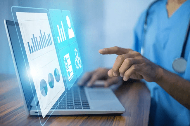 A doctor analyzes a graph displayed on a laptop during a consultation.