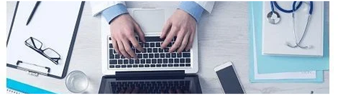 A person typing on a laptop while wearing a stethoscope, suggesting a connection between technology and healthcare.