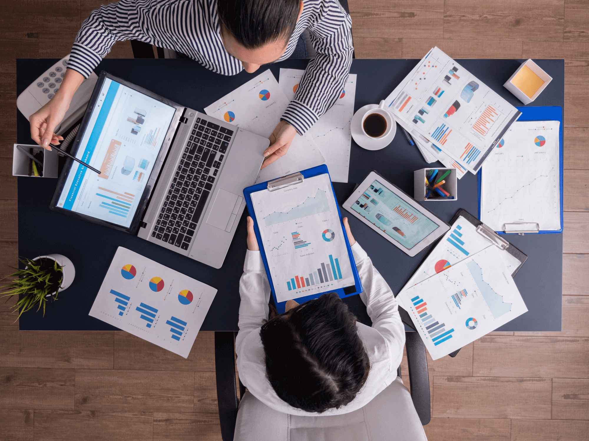 Affordable SEO services for small business shown with a laptop on a desk alongside a notebook, pens, and a mobile phone.