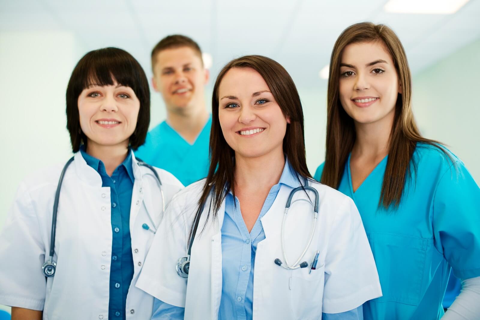 Patients wait at an urgent care reception while staff consult, highlighting the need for effective urgent care marketing services to boost visits.